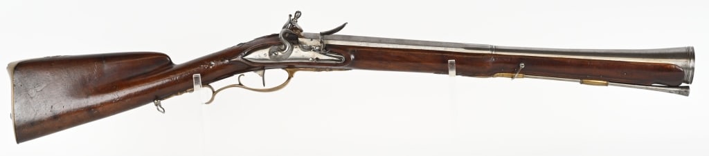FRENCH 18TH CENT. FLINTLOCK BLUNDERBUSS: BARREL 21" MUZZLE DIAMETER 2". This attractive all original Blunderbuss features one piece carved stock, brass hardware, and iron barrel Includes 2 sling swivels and original trumpet tip ram rod. No m