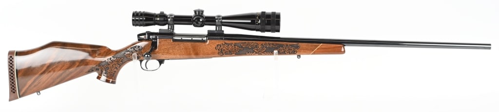 WEATHERBY MARK V LAZERMARK 7MM WEATHERBY MAG: SERIAL NUMBER: H215441. BARREL: 26". CALIBER: 7MM WEATHERBY MAGNUM> MANUFACTURED: 1980S. Made in Japan. Factory blued finish, and carved walnut stock, with oak leaf designs. Monte Carlo butt, with cap