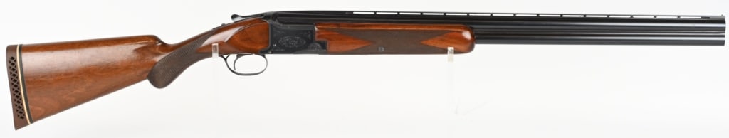 BROWNING SUPERPOSED 12 GAUGE O/U MADE 1953: SERIAL NUMBER: 33688. BARREL: 26-1/2". CALIBER: 12 GAUGE. MANUFACTURED: 1953. Made in Belgium. Vent rib barrel with silver bead front sight. Factory blued finish, with grade 1 engraving on the frame. 