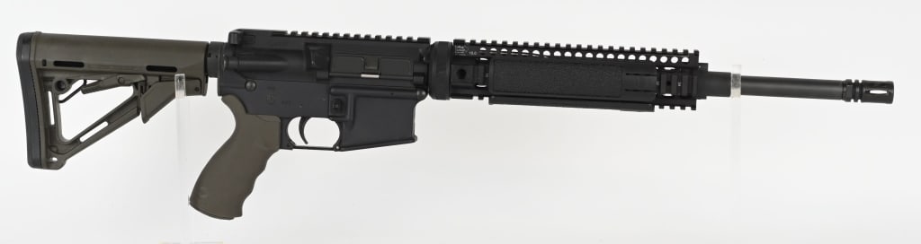 BUSHMASTER XM15-E2S WITH LARUE TACTICAL UPPER: SERIAL NUMBER: BFI508371. BARREL: 16-1/2". CALIBER: 5.56X45MM. MANUFACTURED: 2010S. Larue HBAR profile barrel with A2 flash hider. Low profile gas block, with flat top upper and lower. Black anodized