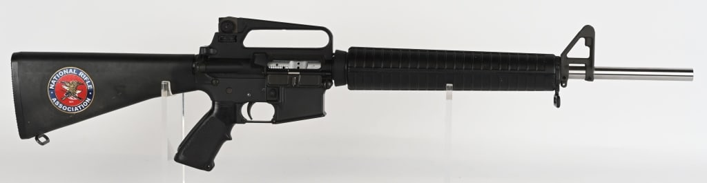 PRE BAN COLT SPORTER MATCH HBAR SEMI AUTO RIFLE: SERIAL NUMBER: MH016186. BARREL: 20-1/2". CALIBER: .223 REM. MANUFACTURED: 1980S/90S. Pre Ban Lower, with an unknown upper. NRA sticker on the right side of the butt. DPMS stainless steel match grade