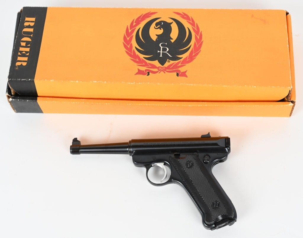 RUGER MARK II STANDARD SEMI AUTOMATIC PISTOL W/BOX: SERIAL NUMBER: 18-28674. BARREL 4-3/4". CALIBER: .22LR. MANUFACTURED: 1982. Blade front sight and u-notch rear sight. Factory blued finish and checkered black plastic grips. Has 1 factory 10 round mag