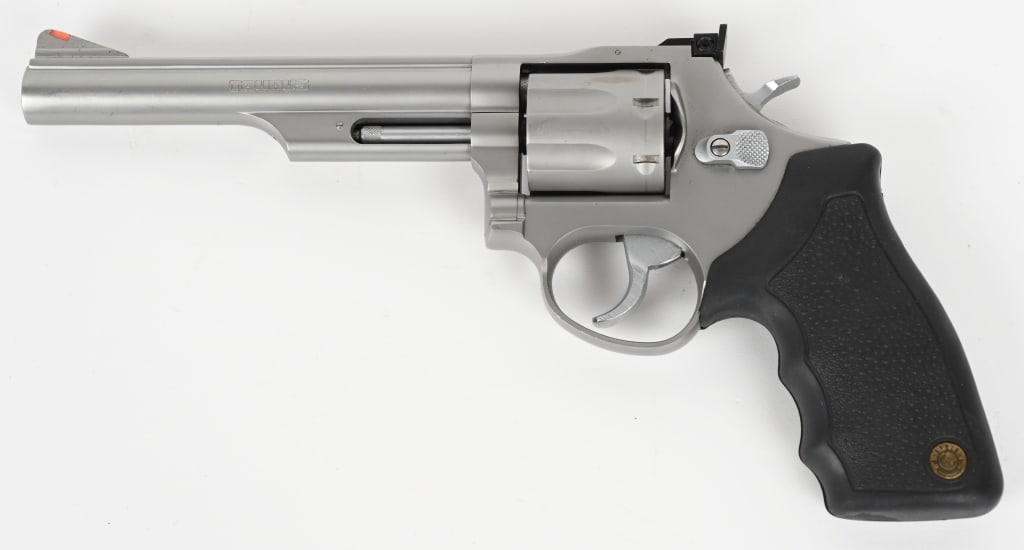 TAURUS MODEL 66 DOUBLE ACTION REVOLVER: SERIAL NUMBER: SD734017. BARREL: 6". CALIBER: .357 MAGNUM. Made in Brazil. Seven shot fluted cylinder. Ramped blade front sight and adjustable u-notch rear. Matte stainless steel finish and textured p