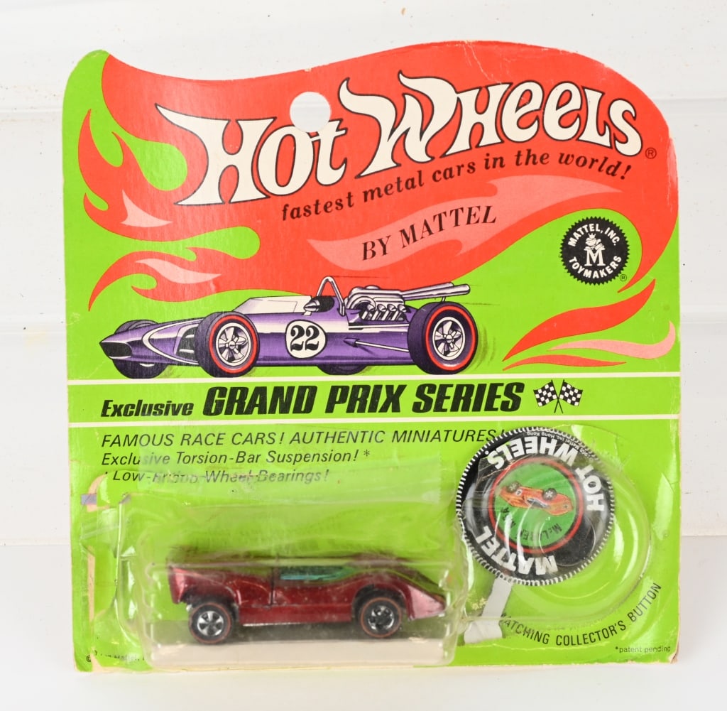 1967 HOT WHEELS REDLINE McLAREN M6A MOC: 1967 Hot Wheels Redline McLaren M6A. Brown in color. Minty sealed on blister pack with button. Bubble is partial loose.