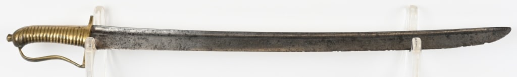 REVOLUTIONARY WAR FRENCH GRENADIER SWORD: One piece cast brass hilt with ribbed grip, crested pommel and stirrup form guard with transverse quillon expansion and rounded junction of the cross guard with the knuckle bow. 24 inch, single fuller