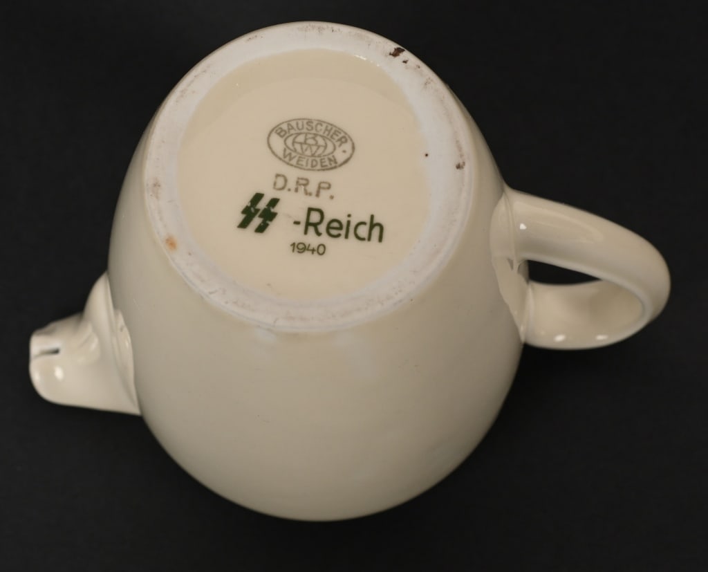 WWII NAZI GERMAN SS REICH MESS HALL CREAMER WW2: 5" tall, approximately 5 3/4" across including handle. Short porcelain creamer with handle. Marked on the bottom "Bauscher Weiden D.R.P. 1940" and "SS REICH." Excellent