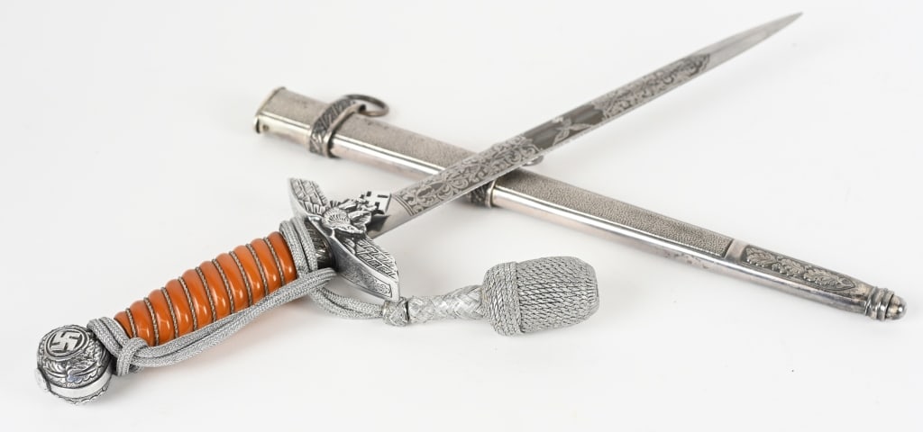 WWII NAZI GERMAN OFFICER DAGGER BY E.PACK WW2: Luftwaffe parts dagger and scabbard. Measures 17-1/8" overall. The front side of the engraved blade has a Luftwaffe flying eagle in the center with a floral pattern on each side. The back side has a f