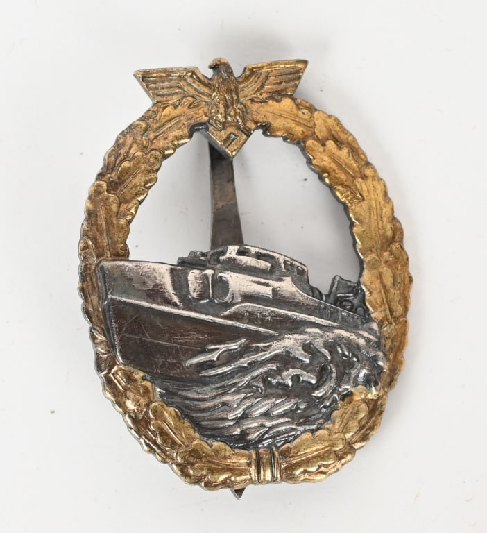WWII NAZI GERMAN E-BOAT BADGE STEINHAUER & LUCK: Nice quality, die struck tombac, semi hollow backed, first pattern S-boat badge with gilt, silver, and burnished charcoal gray finishing. The badge is in the form of a vertically oval, oak-leaf wreath