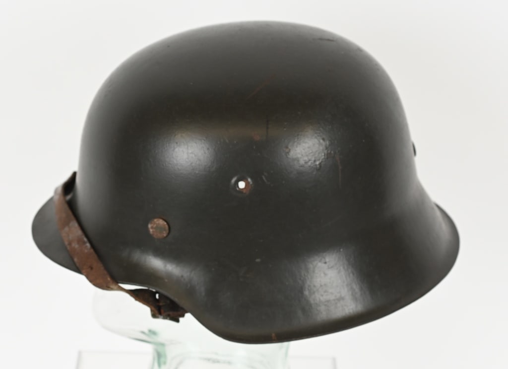 WWII M42 GERMAN COMBAT HELMET W/ LINER ET66 WW2: The stamped, sheet steel construction helmet retains a good portion of its factory applied field-gray paint. All three liner retaining rivets are all intact. The interior of the helmet has a M31, tan,