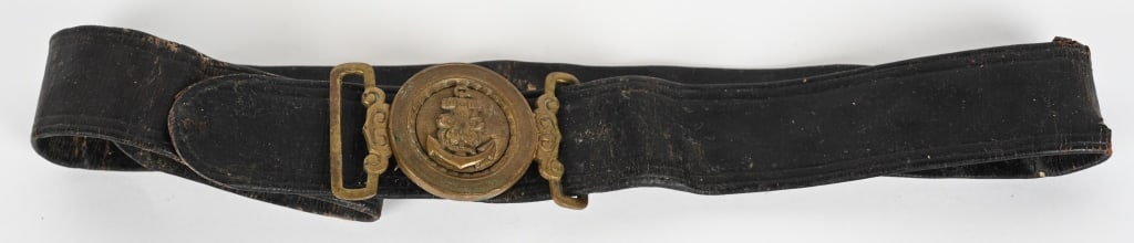 WWII JAPANESE LANDING FORCE BELT & BELT BUCKLE: Japanese Navy Officer’s dual-ply, rubberized leather belt, with a two-piece brass buckle. Riveted over the brass center with a fouled anchor and a cherry blossom superimposed upon it. This piece fit