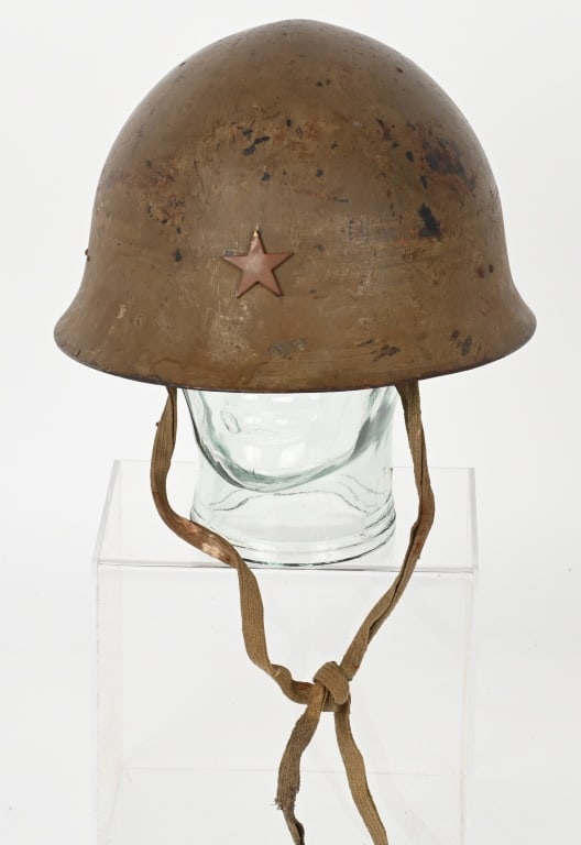 WWII JAPANESE TYPE 90 COMBAT HELMET W CHINSTRAP: The standard WWII Japanese infantry combat helmet. The shell, constructed from chrome polybend steel retains a good portion of its original paint. The original IJA metal star affixed to the front. The