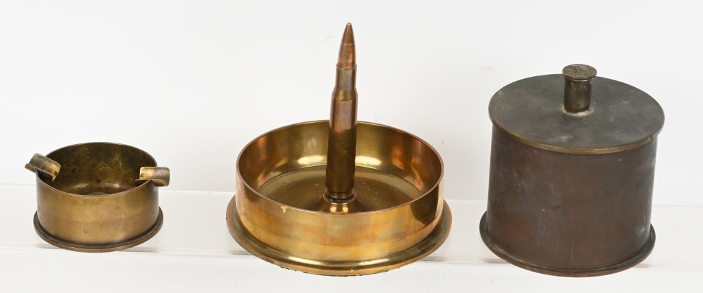 WW1 & WWII GERMAN JAPANESE AMERICAN TRENCH ART: Lot of three pieces of WW1 & WWII Trench Art to include 1) Lidded canister made from an Imperial German shell marked 11 MAI 1918 HL22 FR. NEUMEYER NURNBERG. 2) .50 Cal Ashtray using a very large 