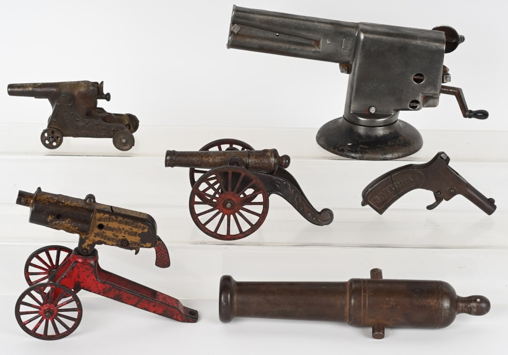 CAST IRON TOY CANNONS, MACHINE GUN & CAP GUN LOT: Lot includes: 1. 12" Master Repeater cast iron cap cannon, not working, 2. 8" Rapid Fire cast iron machine Gun, not working missing crank, 3. 7 1/2", Kenton cast iron gunpowder cannon, 4. Ideal 5 1/2"