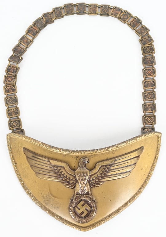 WWII NSDAP POLITICAL LEADER FLAG BEARER'S GORGET: Stamped alloy gorget with a bronze wash. The half-moon shaped gorget measures roughly, 24cm wide from upper tip to tip and 12cm tall. The gorget features a separate, stylized, bronze washed, embossed