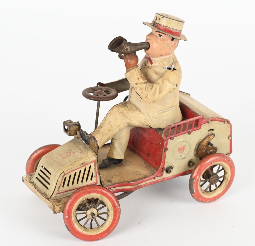 GERMAN LEHMANN TIN WINDUP TUT TUT: The toy is all original and looks like it will clean up better. The windup worked when tested. Missing one light and tab on left arm. Bellows look complete, but do not make a sound. 7" Very Good