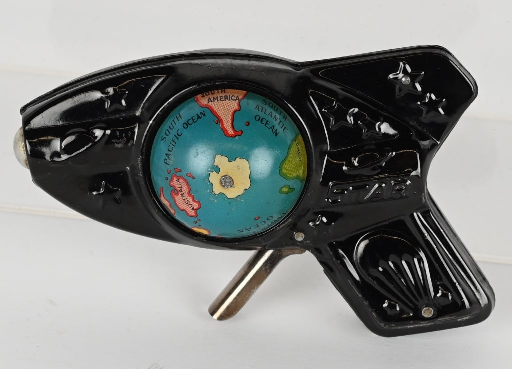 JAPAN TIN GLOBE SPACE SQUIRT GUN: Scarce tin Space Gun. Has colorful moving Globe. Pull trigger and Globe Spins. 4 1/2" Excellent