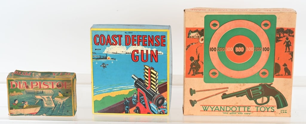 VINTAGE TOY GUN SETS w/ BOXES: Lot includes 1. Baldwin Coast Defense gun with wood shells, 2. Wyandotte No. 3700 Target set, 3. 3- Japan DIA pistols. Wyandotte measures abou 10" by 10". Excellent
