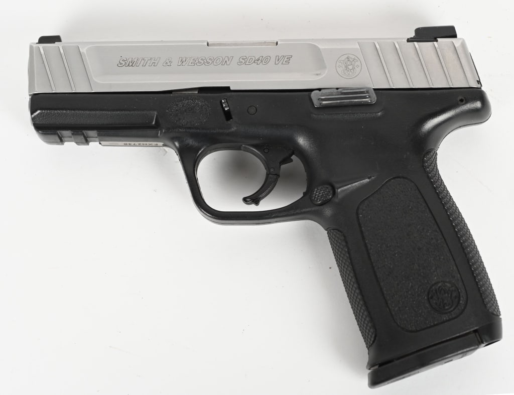 SMITH & WESSON MODEL SD40 VE SEMI AUTO PISTOL: SERIAL NUMBER: FXN2738. BARREL: 4". CALIBER: .40 S&W. MANUFACTURED: 2010S. Standard markings and features. factory 3-dot sights, stainless slide and black polymer frame cut with an accessory rail. Inc