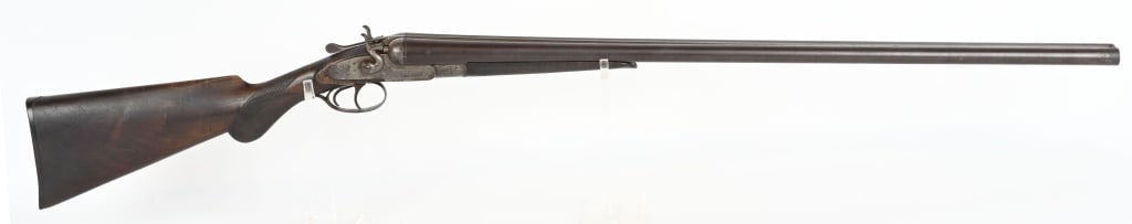 UNION MACHINE 12 GAUGE DOUBLE BARREL SHOTGUN: SERIAL NUMBER: 23038. BARREL: 32". CALIBER: 12 GAUGE. MANUFACTURED: 1890S. Belgian made, with twist steel barrel and a solid rib. Case colored lock and hammers. Oiled wood stock and forearm, with chec