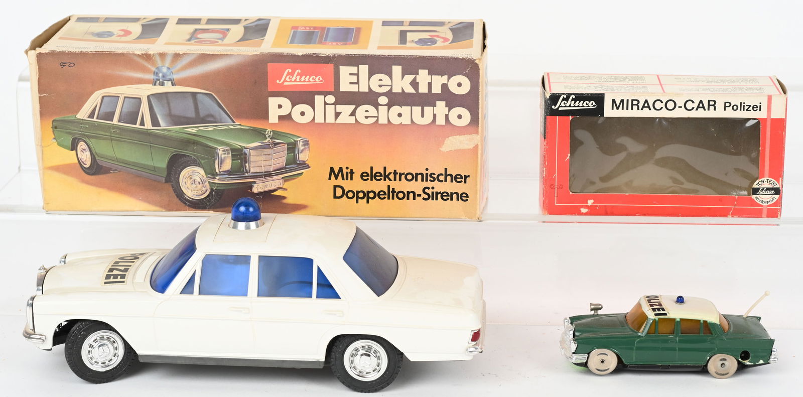 SCHUCO 1001/1P AND 355 242 POLICE CARS w/ BOXES: Includes Elektro Polizeiaute and Micaco-Car Polizei. Both never played with condition. Boxed. Largest 10 1/2" Excellent
