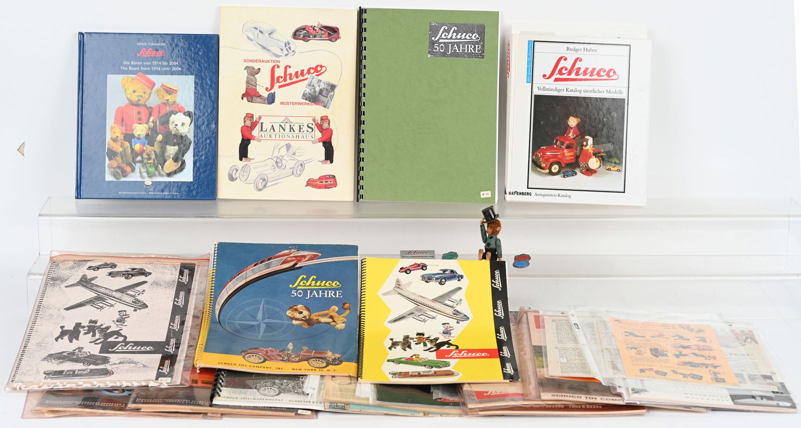SCHUCO CATALOGS, BOOKS, & PINS: Nice lot of Schuco original catalogs, reference books, and pins including Bear. Excellent