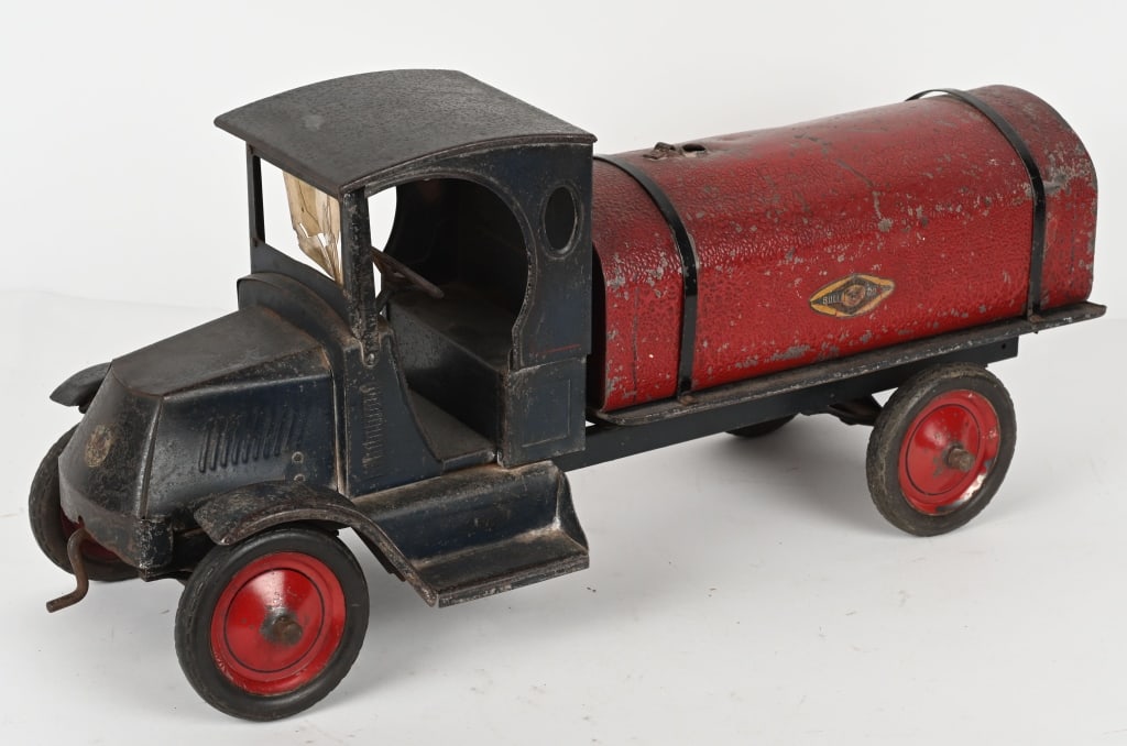 AMERICAN NATIONAL MACK BULL DOG TANK TRUCK: Scarce pressed steel truck. All original with decent paint and decals. Still has partial celluloid windshield. Tank cap is missing. A very hard truck to find in any condition. 28" Very Good-Excellent