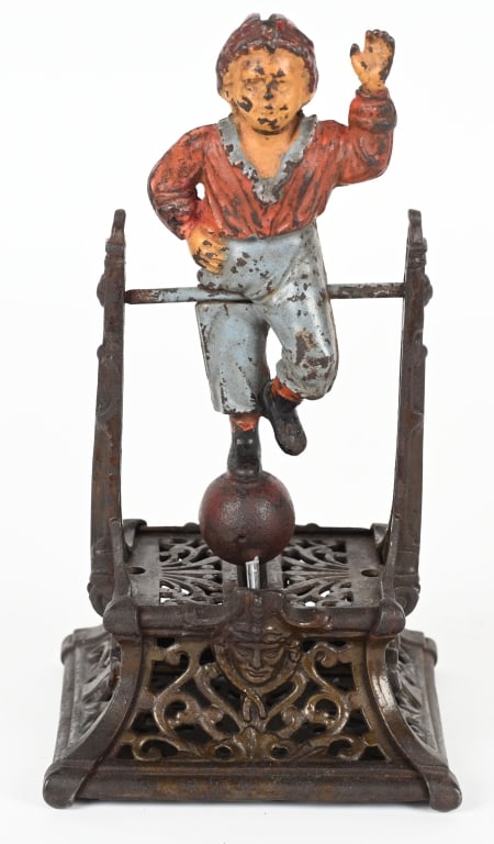 BOY ON TRAPEZE MECHANICAL BANK: Original cast iron bank produced by J. Barton Smith Company of Philadelphia, Pennsylvania circa 1890.. No cracks or repairs. Mechanics work. 9 1/2" Very Good-Excellent