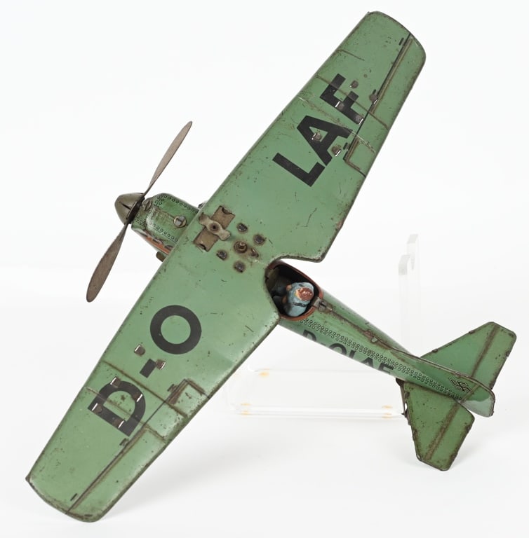 GERMAN TIPPCO TIN WINDUP D-OLAF BOMBER AIRPLANE: Tippco D-OLAF single wing bomber airplane manufactured circa 1940. Windup worked when tested. Has composition pilot. No key is included. Missing bombs. Nice details and colors. Has Nazi insignia on ta