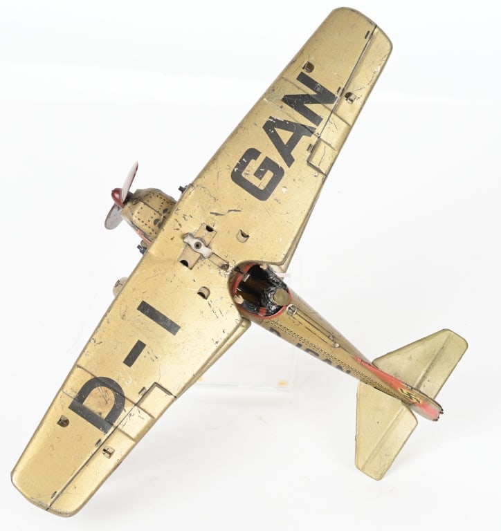 GERMAN TIPPCO TIN WINDUP D-IGAN NAZI BIPLANE: Tippco D-IGAN Bi-plane manufactured circa 1940. Windup worked when tested. Has replaced diecast pilot. No key is included. Nice details and colors. Has Nazi insignia on tail fin. 14 1/2" wingspan by 1