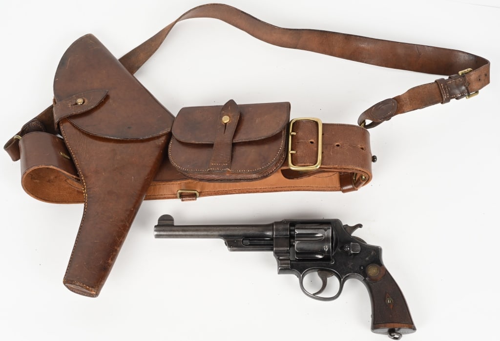 WW1 IDENTIFIED BRITISH OFFICER REVOLVER & RIG: Serial number 4232, 6-1/2 inch barrel. Manufactured 1914. Chambered in .455. Smith & Wesson MK-1British Military issued revolver. Blue with case hardened hammer & trigger. Two-piece checkered walnut g