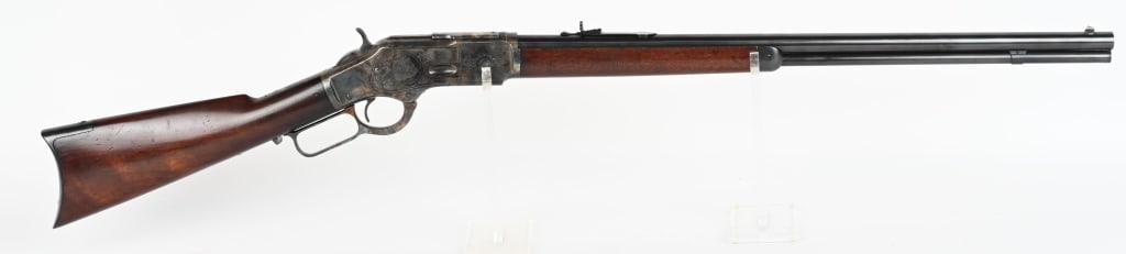 CUSTOM ENGRAVED WINCHESTER MODEL 1873 RIFLE: SERIAL NUMBER: 256047 B BARREL: 24-inch round with full length magazine tube. CALIBER: .32-20 WCF cartridge. MANUFACTURED: 1887. Standard German silver blade front and buckhorn rear barrel sights. Pla