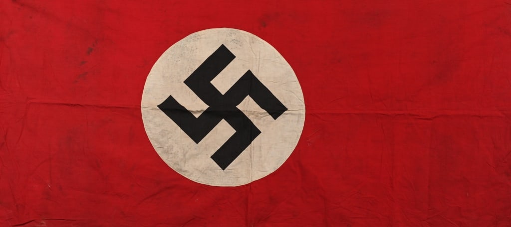 WWII NAZI GERMAN NSDAP SMALL FLAG / BANNER WW2: Roughly 30 x 64 inches, double sided cotton construction pennant. The pennant features a red base field with a separate central white circular disk with a printed canted black swastika to its center.