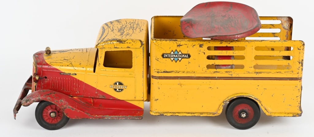 BUDDY L SIT-N-RIDE INTERNATIONAL STAKE TRUCK: All original with decent paint and decals. Truck has electric lights. Has minor damage to front bumper. Missing pull handle and 1 replaced rear wheel. 25" Very Good