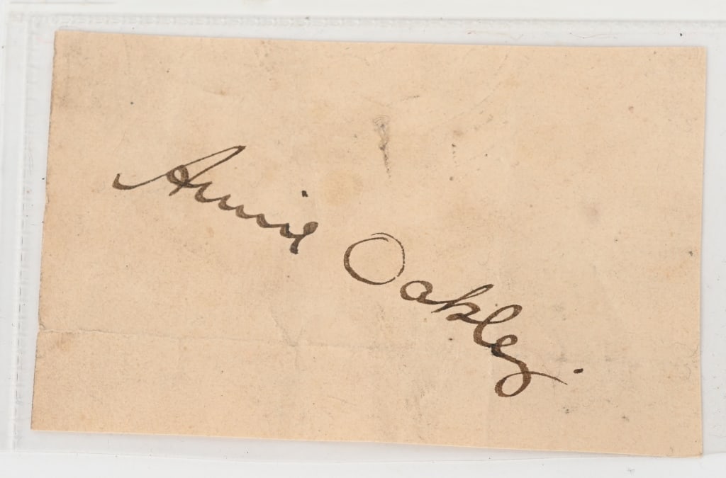 ANNIE OAKLEY SIGNED CARD OF LEGENDARY MARKSWOMAN: Celebrated American performer (1860–1926) whose legendary prowess as a markswoman earned her worldwide renown. At the tender age of fifteen, she bested vaudeville marksman Frank E. Butler in a s