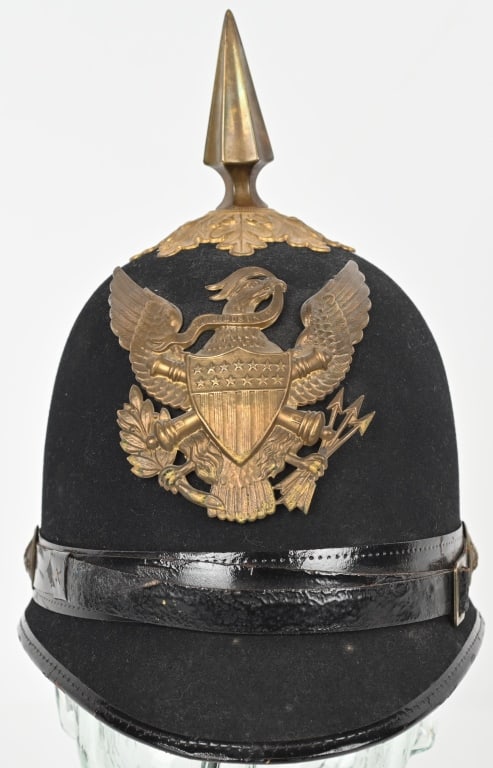 NAMED M1881 INDIAN WARS ARTILLERY SPIKE HELMET: Black felt covered helmet with its original brass insignia and spike by Horstmann & Co. of Philadelphia. The helmet retains its original brass spike and front plate insignia and Artillery side buttons