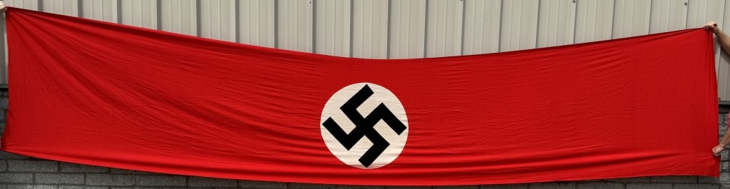 WWII NAZI GERMAN NSDAP WALL BANNER WW2: Multi-piece cotton construction banner approximately 48 X 216" inches. To both its red fields are sewn white disks, with a printed mobile swastikas in black. Excellent. Probably one of the most recogn