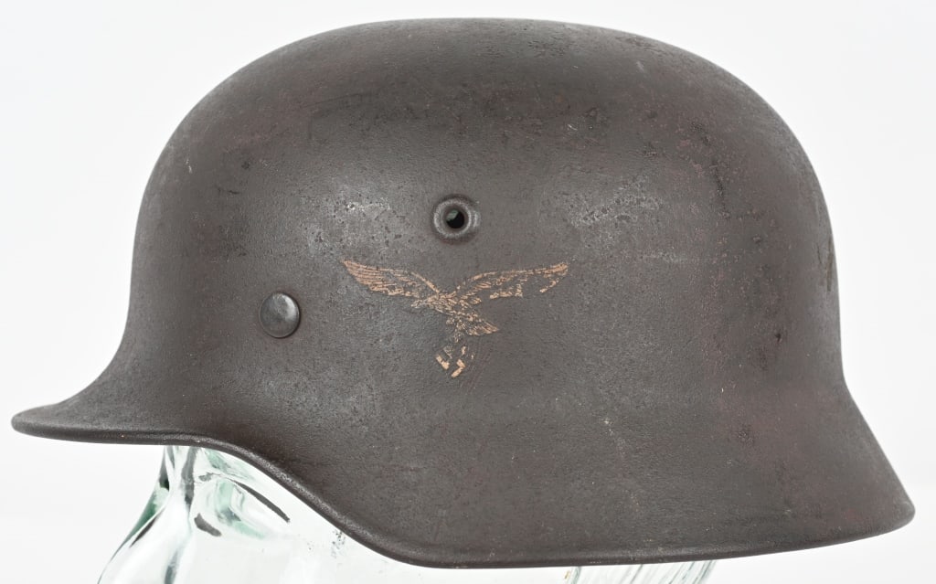 WWII NAZI GERMAN LUFTWAFFE M40 COMBAT HELMET Q66: The stamped, sheet steel construction M40 helmet retains about a good portion of its slightly rough textured, Luftwaffe blue/gray paint. The left side of the helmet has a second pattern, (circa 1936/1