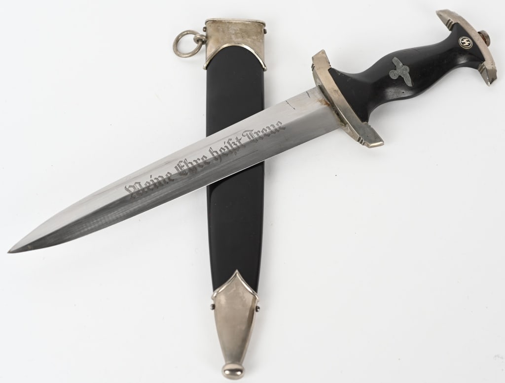 WWII NAZI GERMAN M33 WAFFEN SS DAGGER 1053/38 WW2: Dagger features a roughly, 22cm long, double edged, drop forged steel construction, nickel/silver plated blade with a low central ridge. The nickel/silver plated blade shows sharpening and pitting. Th