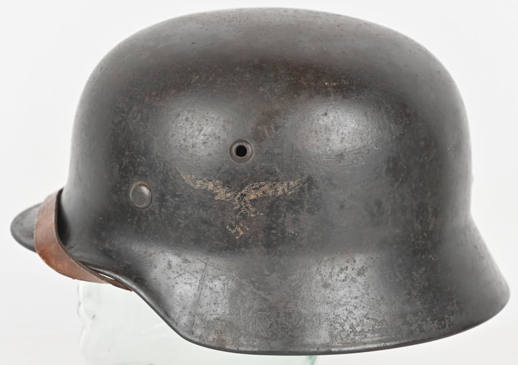 WWII NAZI GERMAN LUFTWAFFE M40 COMBAT HELMET Q66: The stamped, sheet steel construction M40 helmet retains about a good portion of its slightly rough textured, Luftwaffe blue/gray paint. The left side of the helmet has a second pattern, (circa 1936/1
