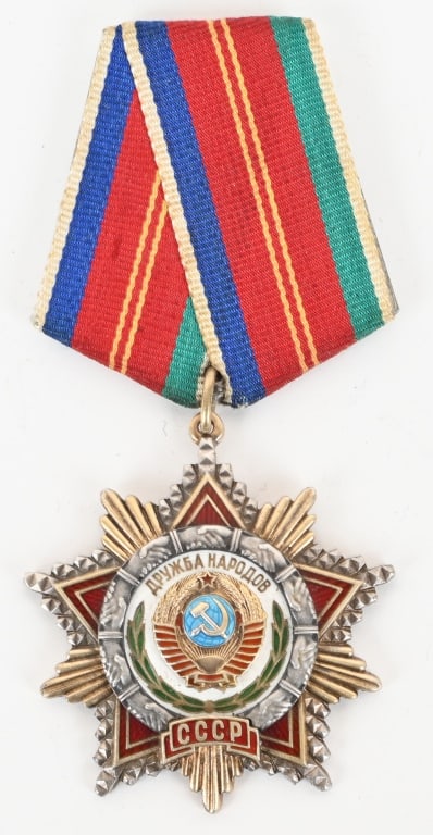 SOVIET RUSSIAN ORDER OF FRIENDSHIP OF PEOPLES: Multi-piece construction, silver gilt and enamels, Monetny Dvor mint marked and number hand engraved "4205" on the reverse, 47 mm x 47.8 mm, original ribbon, mounted to a five-sided aluminum suspensio