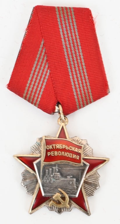 SOVIET ORDER OF THE OCTOBER REVOLUTION: Instituted in 1967. Three-piece construction, in silver with red enamels, the hammer and sickle insignia in silver gilt, mint marked (Monetny Dvor) and number engraved "80.163" on the reverse, measuri