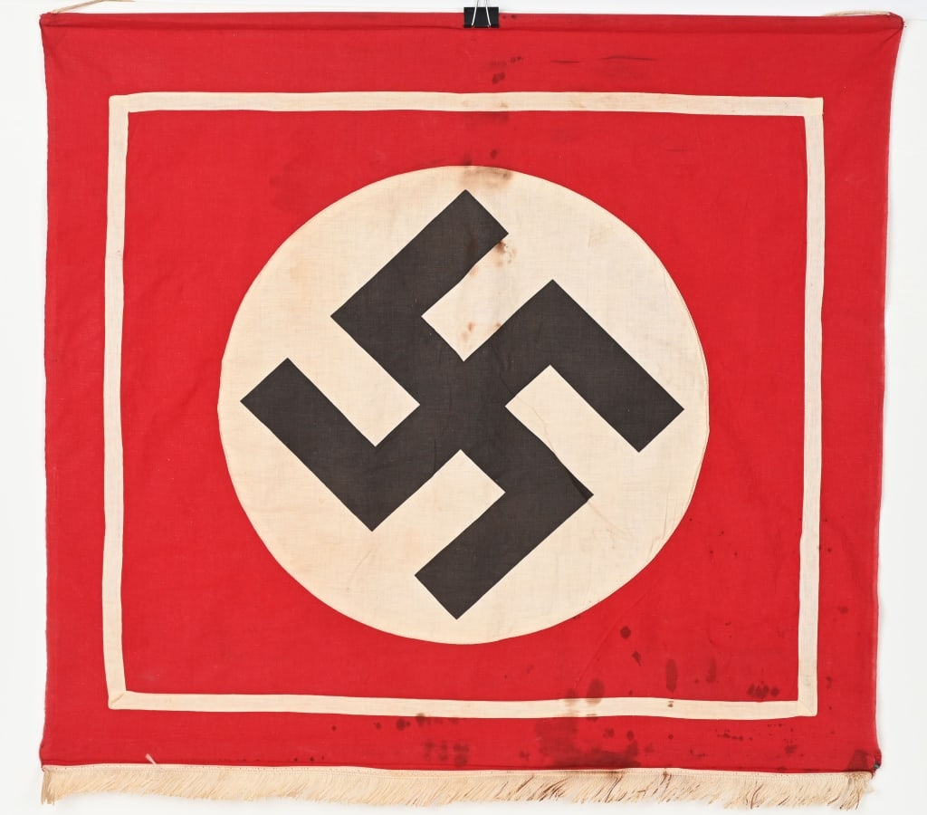 WWII NAZI GERMAN NSDAP POLITICAL PODIUM BANNER WW2: Approximately 31 X 28, single sided multi-piece woven cotton construction banner features a red base field with a separate, machine stitched white circular field to the center with a black printed can