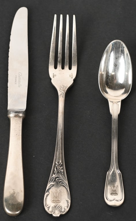 SADDAM HUSSEIN SILVER TABLEWARE PALACE IN BAGHDAD: 3 pieces of sterling silver tableware once owned and used by Iraqi dictator Saddam Hussein, composed of a 7 in. fork, 5 1/2 spoon, and a 7 3/4 inch butter knife each bearing a scallop-edged design and