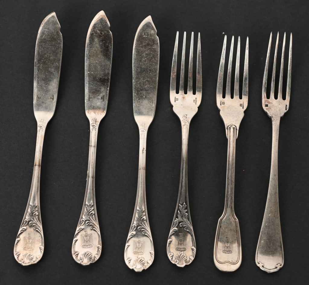 SADDAM HUSSEIN SILVER TABLEWARE PALACE IN BAGHDAD: 6 pieces of sterling silver tableware once owned and used by Iraqi dictator Saddam Hussein, composed of 3 6 1/4 in. forks, and 3 7 3/4 inch butter knives. each bearing a scallop-edged