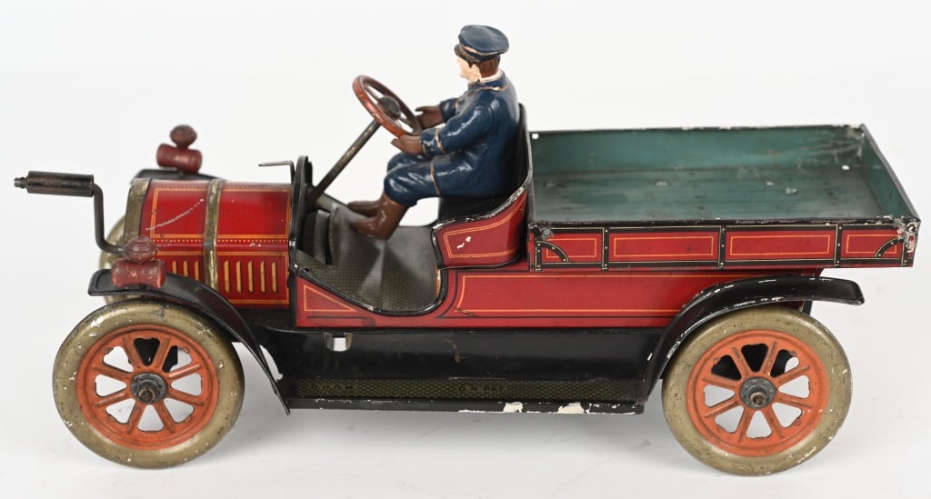 HESS CLOCKWORK EARLY OPEN TRUCK: Great looking early Open Truck. Has great colors and details. Front crank windup works. Driver and wood headlamps. replaced. A very unusual German car. 10" Excellent