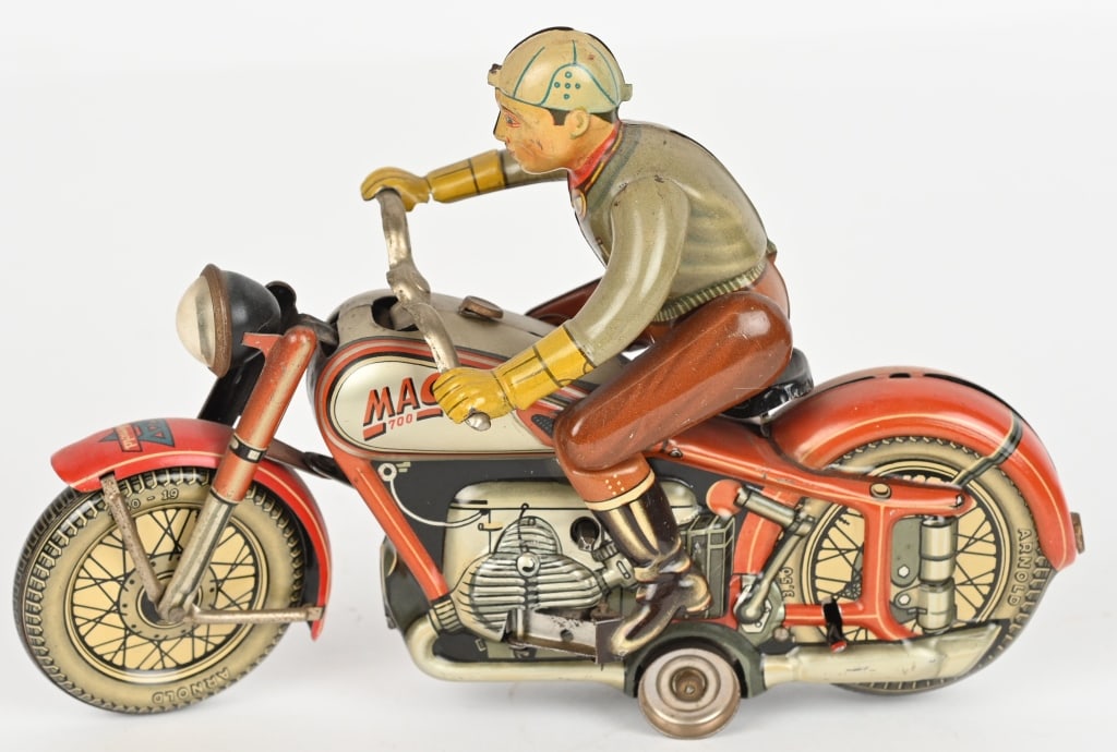 ARNOLD TIN WINDUP MAC 700 MOTORCYCLE, RED: German windup MAC 700 Motorcycle. Windup works and riders gets off and on. Includes original key. Has some fading. 7 1/2" Very Good-Excellent