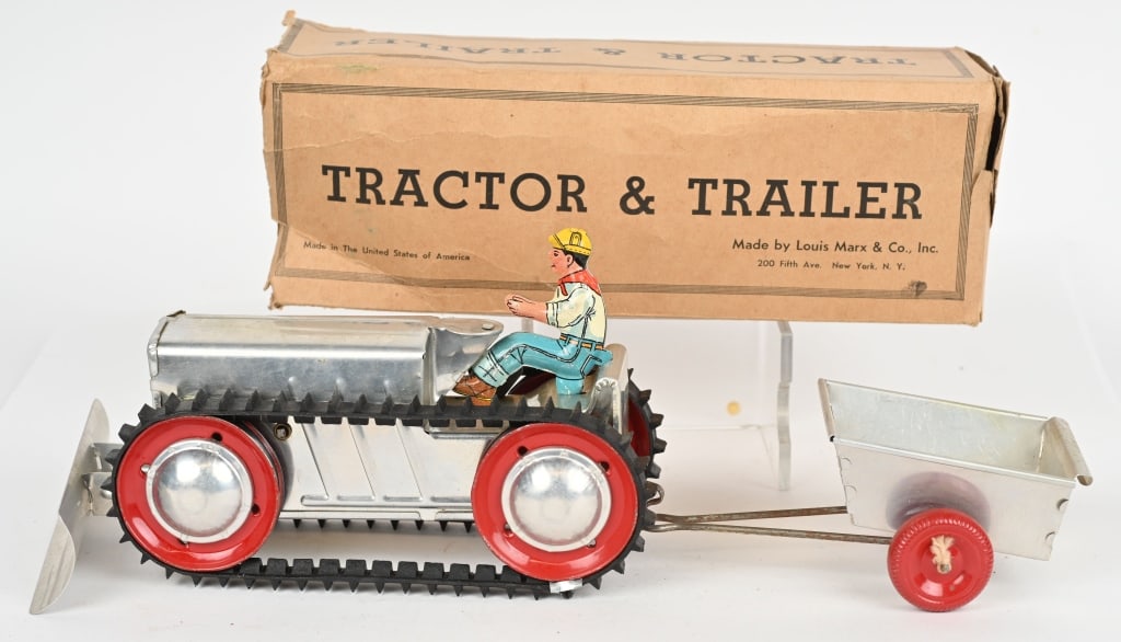 MARX WINDUP TRACTOR & TRAILER w/ BOX: Made of aluminum with tin driver. Complete with trailer and plow. Windup works. Original box is missing one set of end flaps. 16" with plow and trailer attached. Excellent