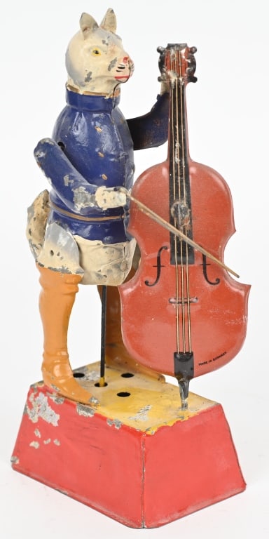 GERMAN HANDPAINTED TIN WIND-UP CAT PLAYING CELLO: Hand painted tin cat mounted on base, plays cello with plink-plink music. Tail wags as he strums the cello. Has paint loss and some touch up. Displays great. 9" Very Good