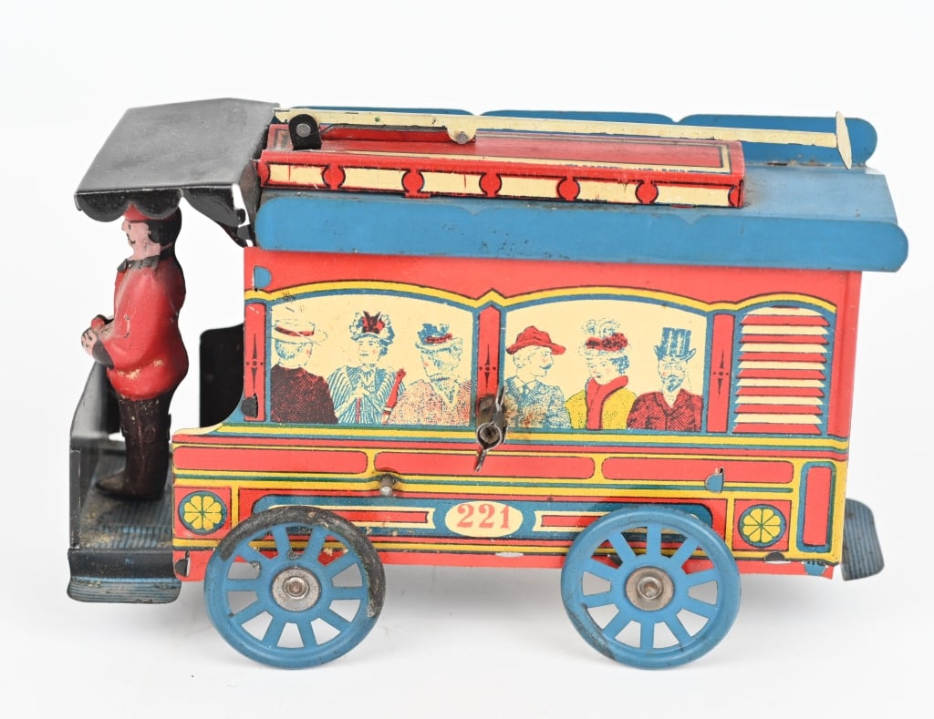 OROBR TIN WINDUP TROLLEY: German tin windup Trolley attributed to Orobr, or perhaps Rictor. Features full figure driver and people litho in the windows. Complete and original with bright colors. One wheel has loss. Windup work