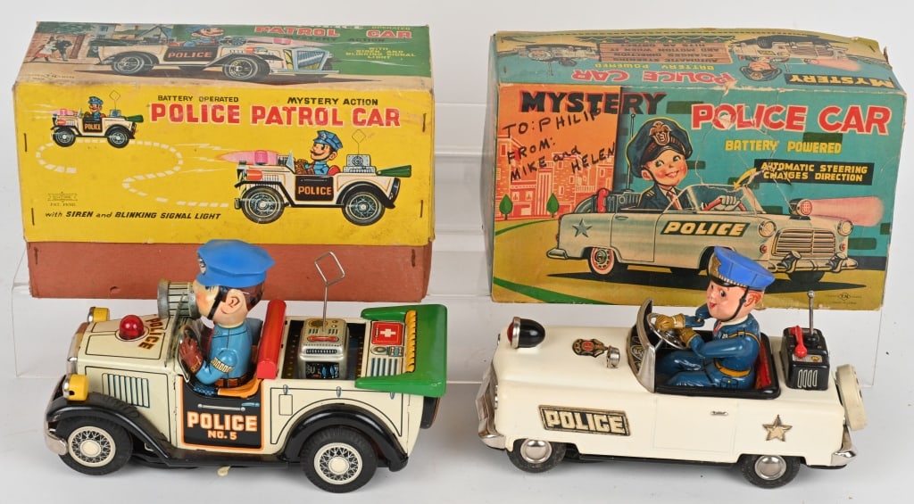 2- JAPAN TIN BATTERY OP POLICE CARS w/ BOXES: Lot includes 1. 9" T.N. Police Patrol Car, worked when tested, 2. 9" T.N. Mystery Police Car, lights up but not working, box has taped repairs. Excellent